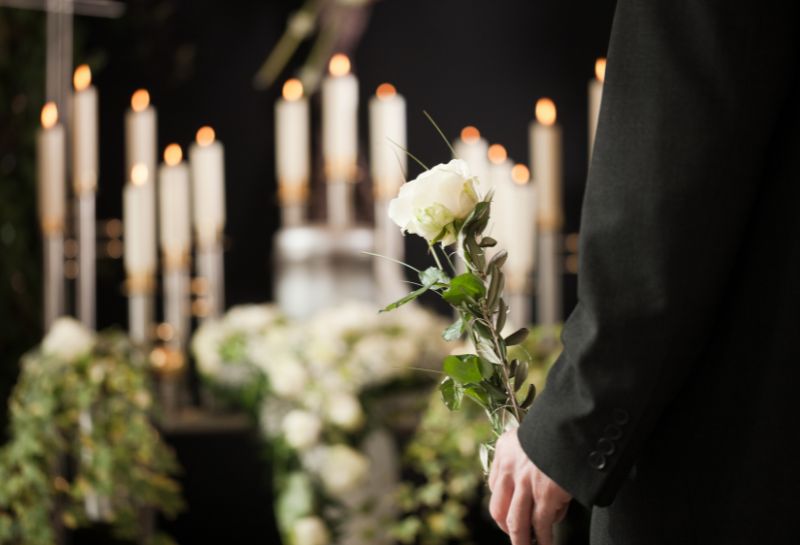 man holding flowers at a ceremony